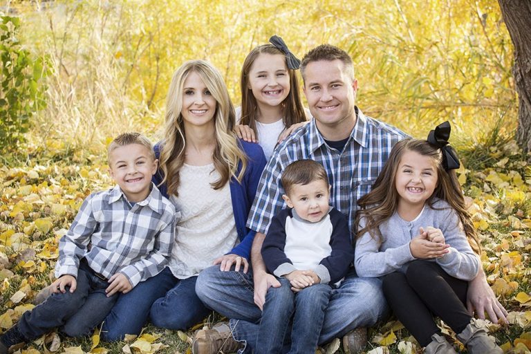 Blended family posing for family photo.